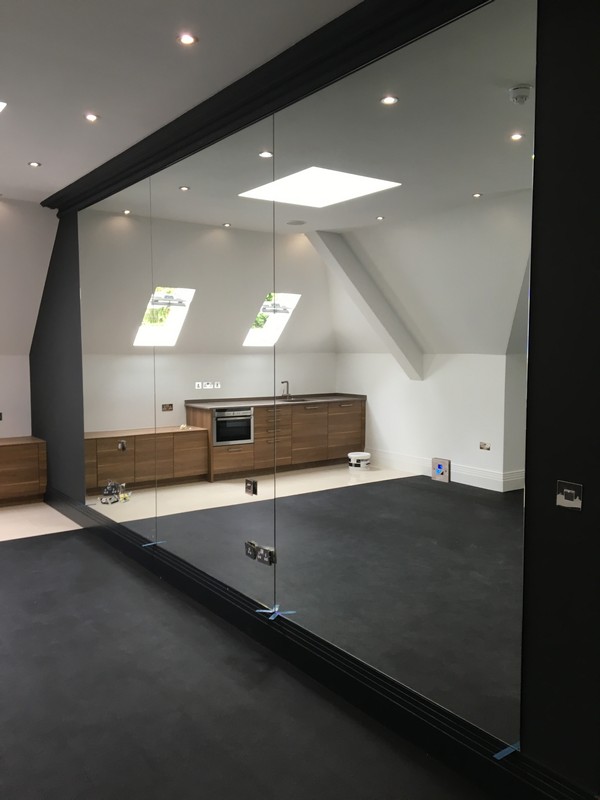 Frameless glass partition in loft conversion by Oxford glaziers